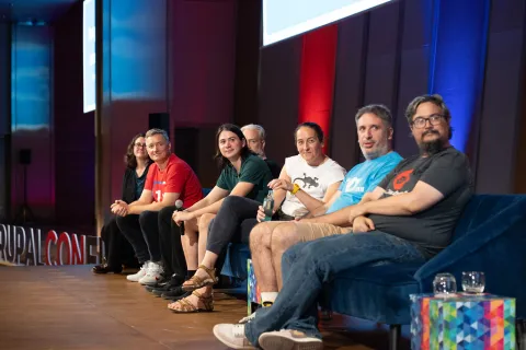 DrupalCon Barcelona 2024 Drupal CMS Track Leads Keynote participants looking at the podium, where Gábor Hójtsy was introducing the keynote