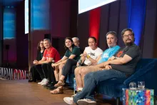 DrupalCon Barcelona 2024 Drupal CMS Track Leads Keynote participants looking at the podium, where Gábor Hójtsy was introducing the keynote